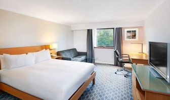 Spacious king room with TV, comfortable work desk and natural light at Hilton London Watford.