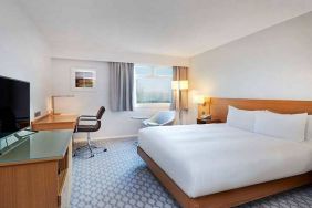 comfortable king room with TV and work desk at Hilton London Watford.