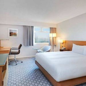 comfortable king room with TV and work desk at Hilton London Watford.