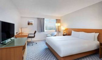 Comfortable king room with TV and work desk at Hilton London Watford.