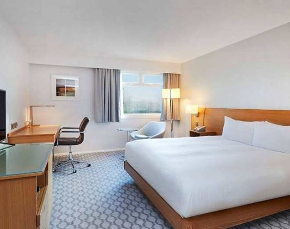 Comfortable king room with TV and work desk at Hilton London Watford.