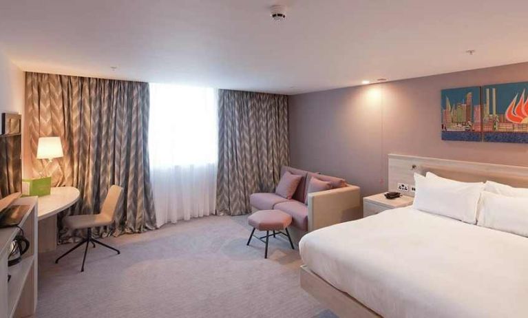 spacious king room with TV, work desk, and lounger at Hampton by Hilton Leeds City Centre.