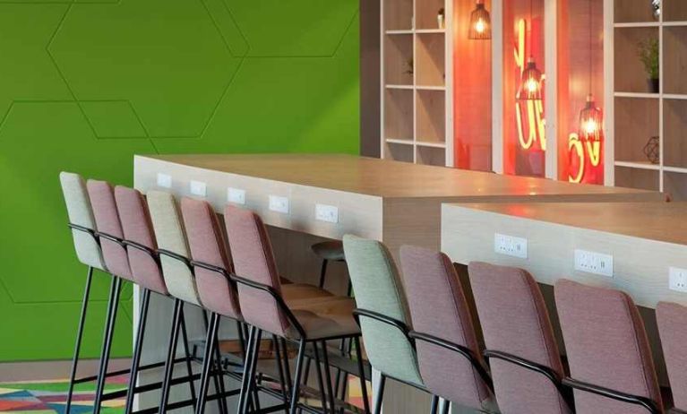 comfortable coworking desks with charging stations ideal for digital nomads working online at Hampton by Hilton Leeds City Centre.