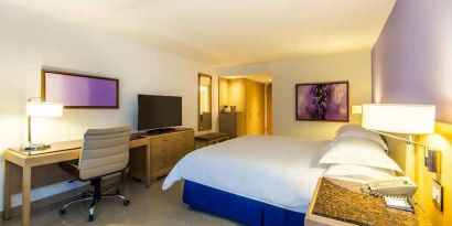 spacious king suite with TV and work desk at Hilton Cartagena Hotel.