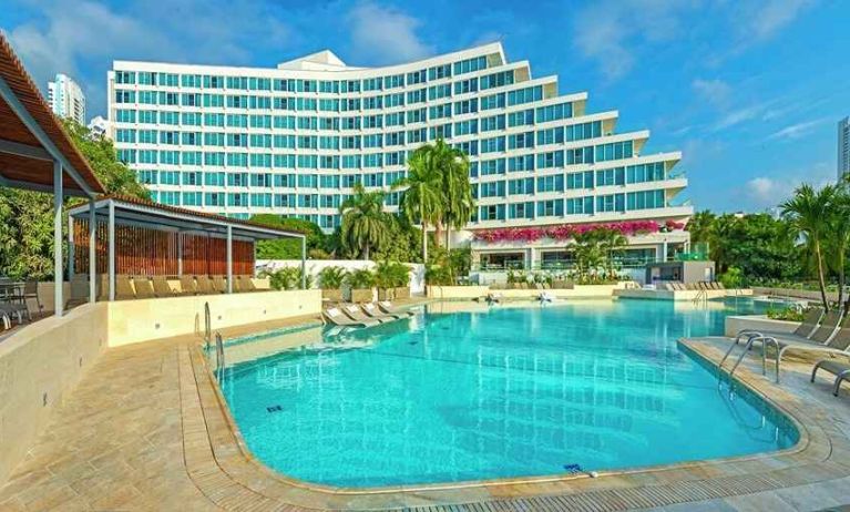 beautiful outdoor pool with sun beds at Hilton Cartagena Hotel.