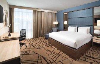 spacious king room with work desk and TV at Hilton Garden Inn Bogota Airport.