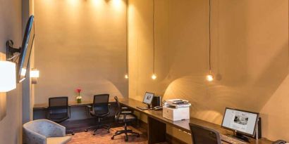 dedicated business center with PC, internet, work desks, and printer at Hilton Garden Inn Bogota Airport.