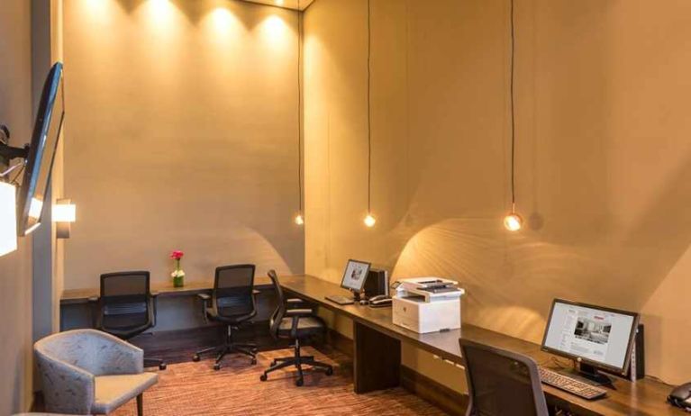 dedicated business center with PC, internet, work desks, and printer at Hilton Garden Inn Bogota Airport.