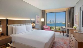 beautiful king room with work desk, TV, and water/city views at DoubleTree by Hilton Sharjah Waterfront Hotel & Residences.