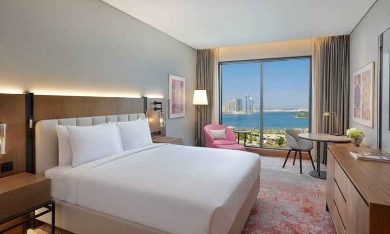 beautiful king room with work desk, TV, and water/city views at DoubleTree by Hilton Sharjah Waterfront Hotel & Residences.