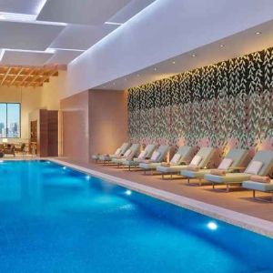 gorgeous indoor pool with pool beds at DoubleTree by Hilton Sharjah Waterfront Hotel & Residences.