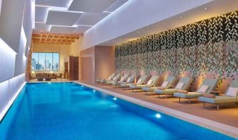 gorgeous indoor pool with pool beds at DoubleTree by Hilton Sharjah Waterfront Hotel & Residences.