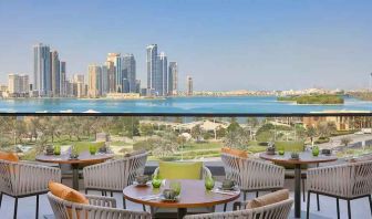 lovely outdoor terrace with gorgeous water/city views ideal as a coworking space at DoubleTree by Hilton Sharjah Waterfront Hotel & Residences.