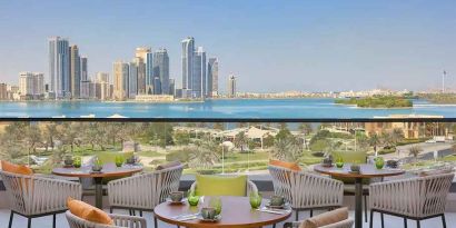 lovely outdoor terrace with gorgeous water/city views ideal as a coworking space at DoubleTree by Hilton Sharjah Waterfront Hotel & Residences.