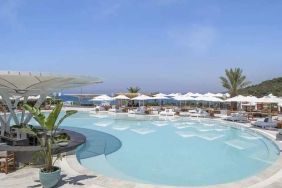 beautiful outdoor pool surrounded by seating and sun beds at Susona Bodrum, LXR Hotels & Resorts.