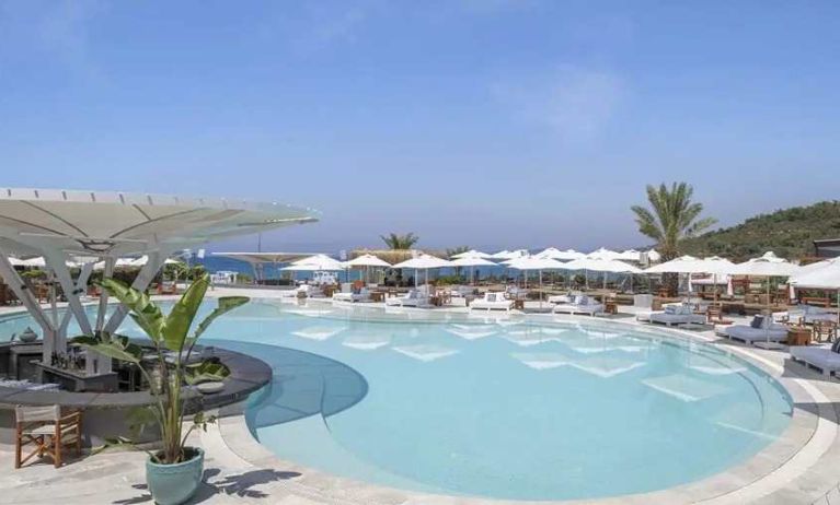 beautiful outdoor pool surrounded by seating and sun beds at Susona Bodrum, LXR Hotels & Resorts.