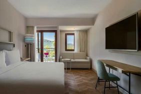 spacious king room with lots of natural light, sea view, TV, and work desk at DoubleTree by Hilton Bodrum Isil Club Resort.