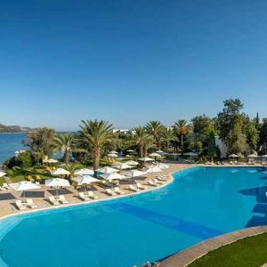 stunning outdoor pool surrounded by sun beds and pool umbrellas at DoubleTree by Hilton Bodrum Isil Club Resort.