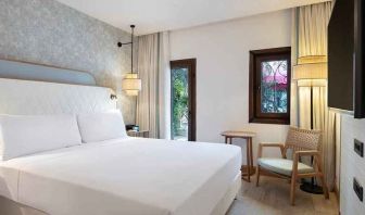 comfortable delux king room with TV and natural light at DoubleTree by Hilton Bodrum Marina Vista.