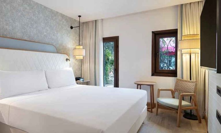 comfortable delux king room with TV and natural light at DoubleTree by Hilton Bodrum Marina Vista.