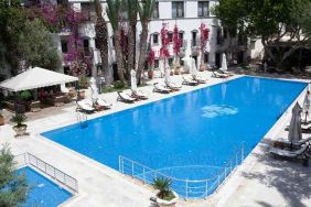 beautiful outdoor pool surrounded by seating and sun beds at DoubleTree by Hilton Bodrum Marina Vista.