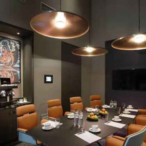 Meeting room with TV screen and coffee machine at the Hilton Amsterdam Airport Schiphol.