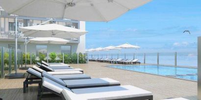 Relaxing outdoor pool area with lounges at the Hilton Garden inn Casablanca Sud.