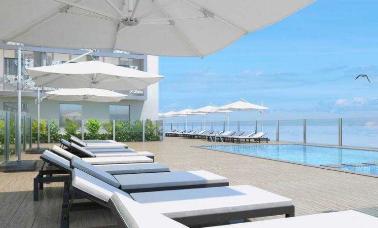 Relaxing outdoor pool area with lounges at the Hilton Garden inn Casablanca Sud.