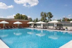 stunning outdoor pool with sun beds and umbrellas at Hilton Istanbul Bakirkoy.