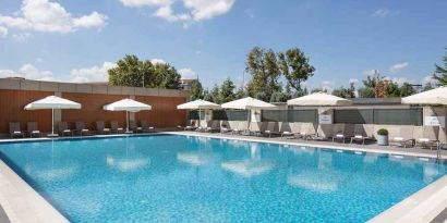 stunning outdoor pool with sun beds and umbrellas at Hilton Istanbul Bakirkoy.