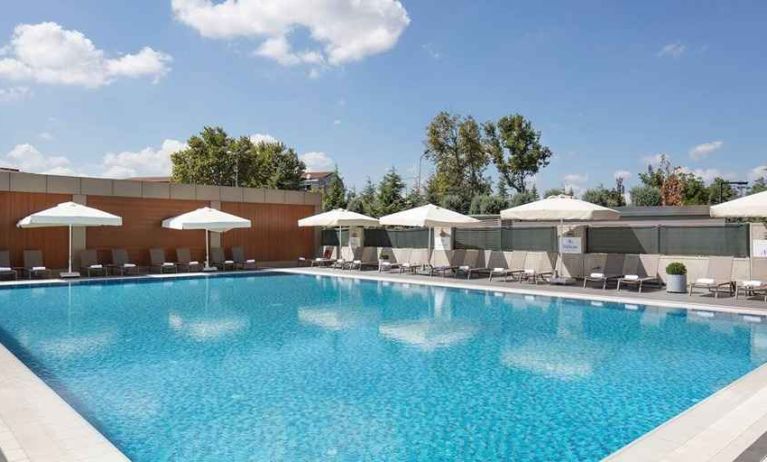 stunning outdoor pool with sun beds and umbrellas at Hilton Istanbul Bakirkoy.