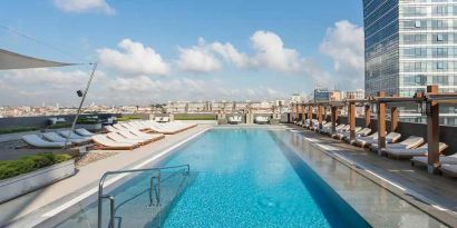 stunning outdoor pool with sun beds at Hilton Istanbul Bomonti Hotel & Conference Center.