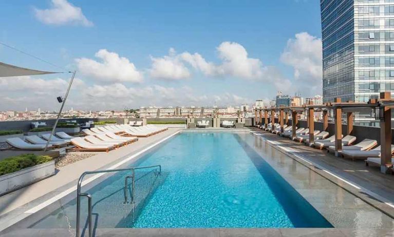 stunning outdoor pool with sun beds at Hilton Istanbul Bomonti Hotel & Conference Center.