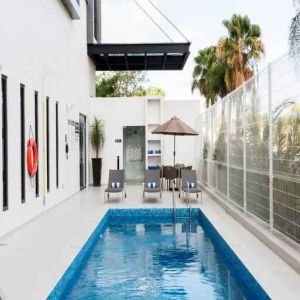 Relaxing outdoor pool at the Hampton Inn by Hilton Cancun Cumbres.