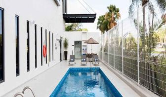 Relaxing outdoor pool at the Hampton Inn by Hilton Cancun Cumbres.