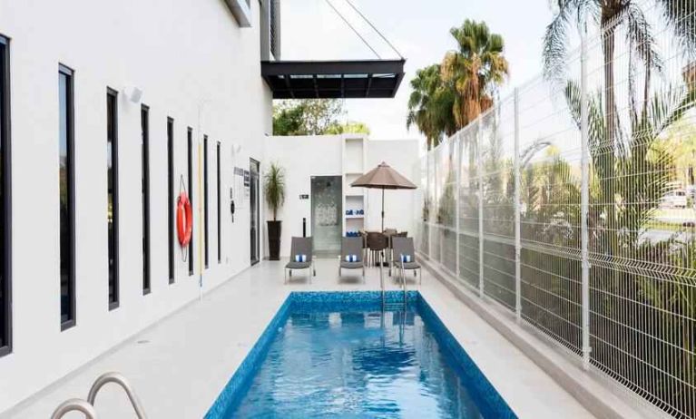 Relaxing outdoor pool at the Hampton Inn by Hilton Cancun Cumbres.