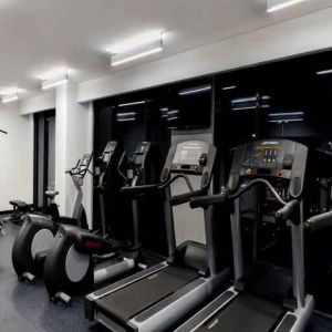 Fitness center with treadmills and machines at the Hampton Inn by Hilton Cancun Cumbres.