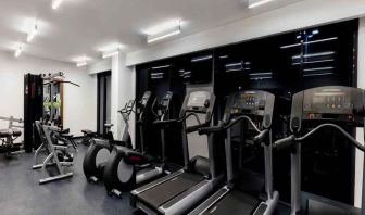 Fitness center with treadmills and machines at the Hampton Inn by Hilton Cancun Cumbres.