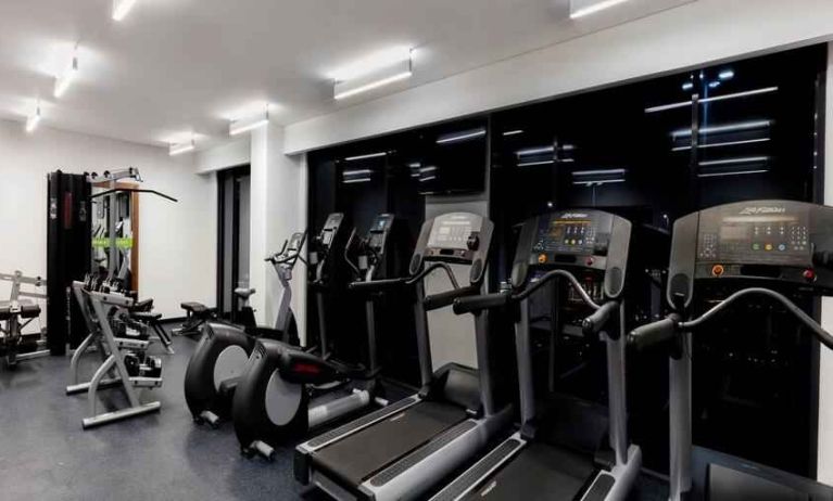 Fitness center with treadmills and machines at the Hampton Inn by Hilton Cancun Cumbres.