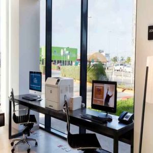 Working station with computers and printer at the Hampton Inn by Hilton Cancun Cumbres.