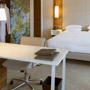 luxurious king suite with business desk ideal for working remotely at Hilton Barcelona.