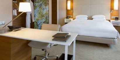 luxurious king suite with business desk ideal for working remotely at Hilton Barcelona.