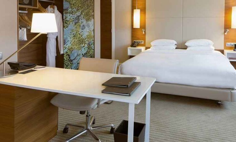 luxurious king suite with business desk ideal for working remotely at Hilton Barcelona.