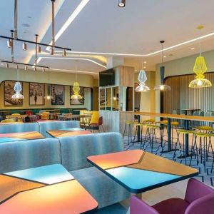 colorful lobby and coworking space ideal for working remotely at Hampton by Hilton Alcobendas Madrid.