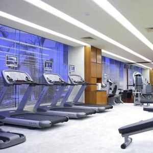 well equipped fitness center with treadmills, bikes, and weights at Hilton Guangzhou Science City.