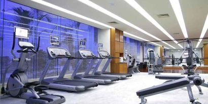 well equipped fitness center with treadmills, bikes, and weights at Hilton Guangzhou Science City.