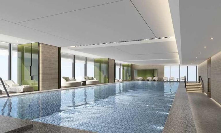 beautiful indoor pool large enough to do laps, surrounded by sun beds at DoubleTree by Hilton Kunming Airport.