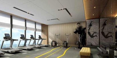 well equipped fitness center with lots of natural light at DoubleTree by Hilton Kunming Airport.