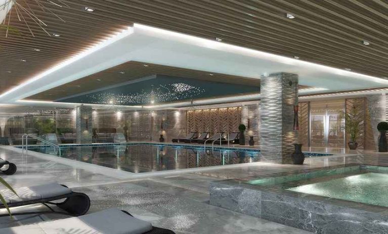 luxurious indoor pool surrounded by sunbeds at DoubleTree by Hilton Manisa.