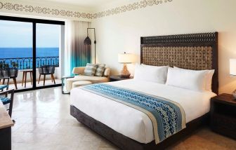 King bedroom with working station overlooking the ocean at the Hilton Los Cabos Beach & Golf Resort.